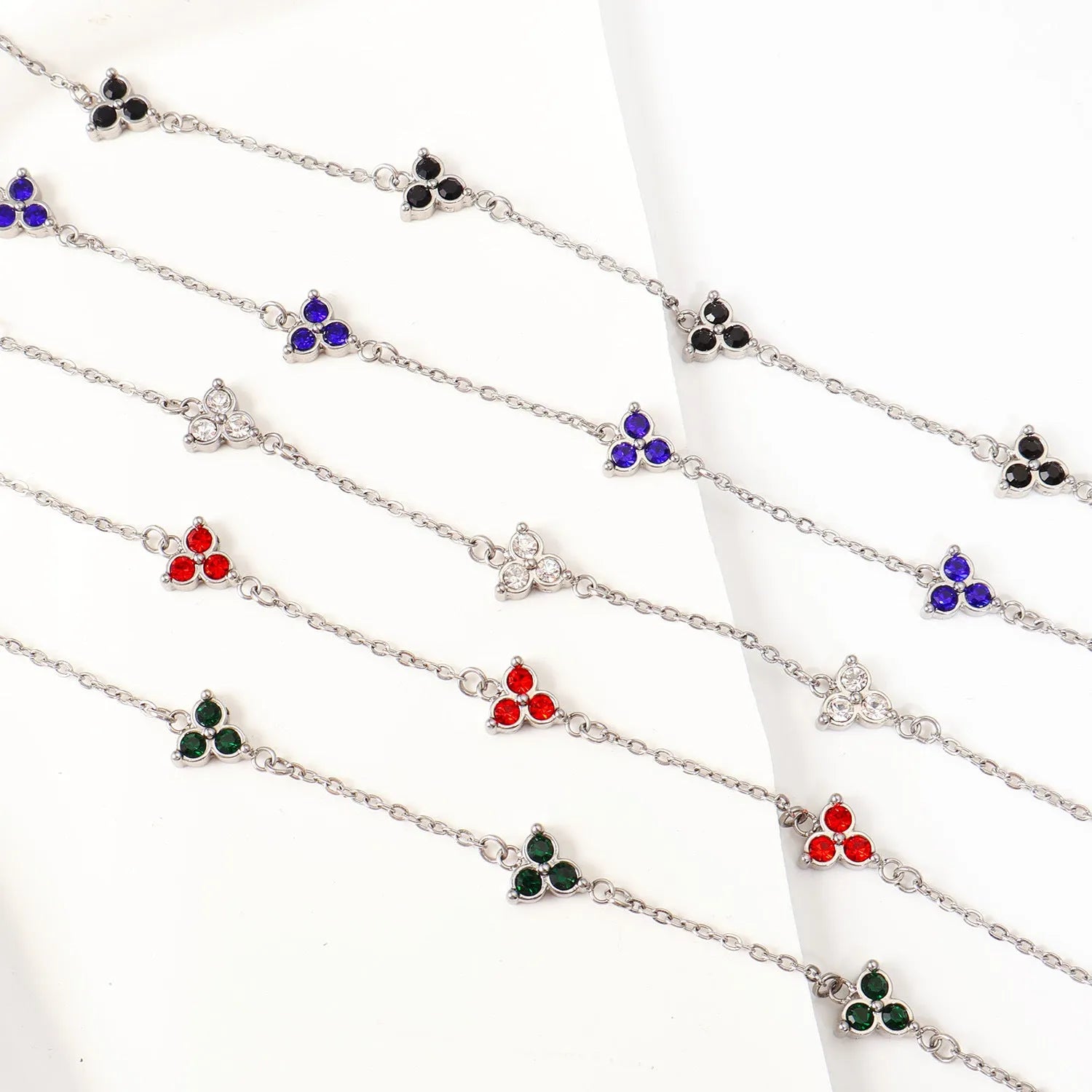 Stainless steel women's bracelet with three geometric diamond charms and zircon gemstones