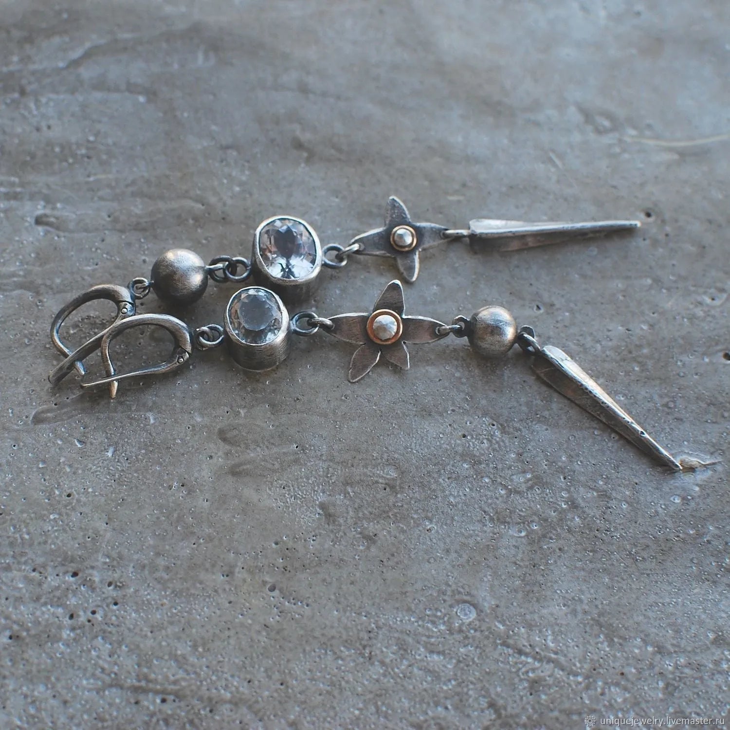 Geometric antique silver earrings with rhinestone accents and XINGX pendant design