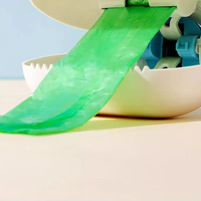 White blue and beige coloured cloud jaw design dog pooper scooper on a green lawn.