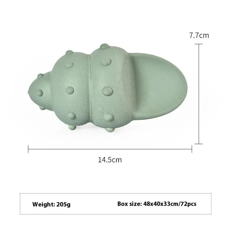 Blue and green rubber dog toys shaped as a shark, a conch, and a starfish on a white background.