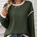 Women's beige knit top with Four Leaf Clover design, drop shoulders, and contrast trim.