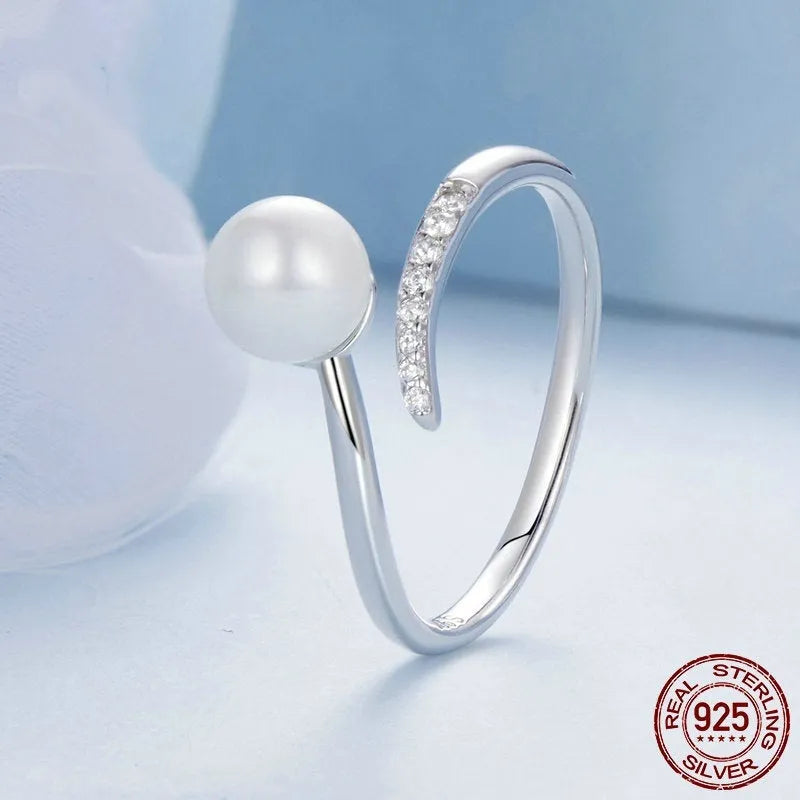 Shell pearls ring with S925 sterling silver construction and adjustable open loop design featuring natural pearl accent