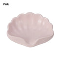 White and pink plastic shell-shaped soap dish for bathroom use