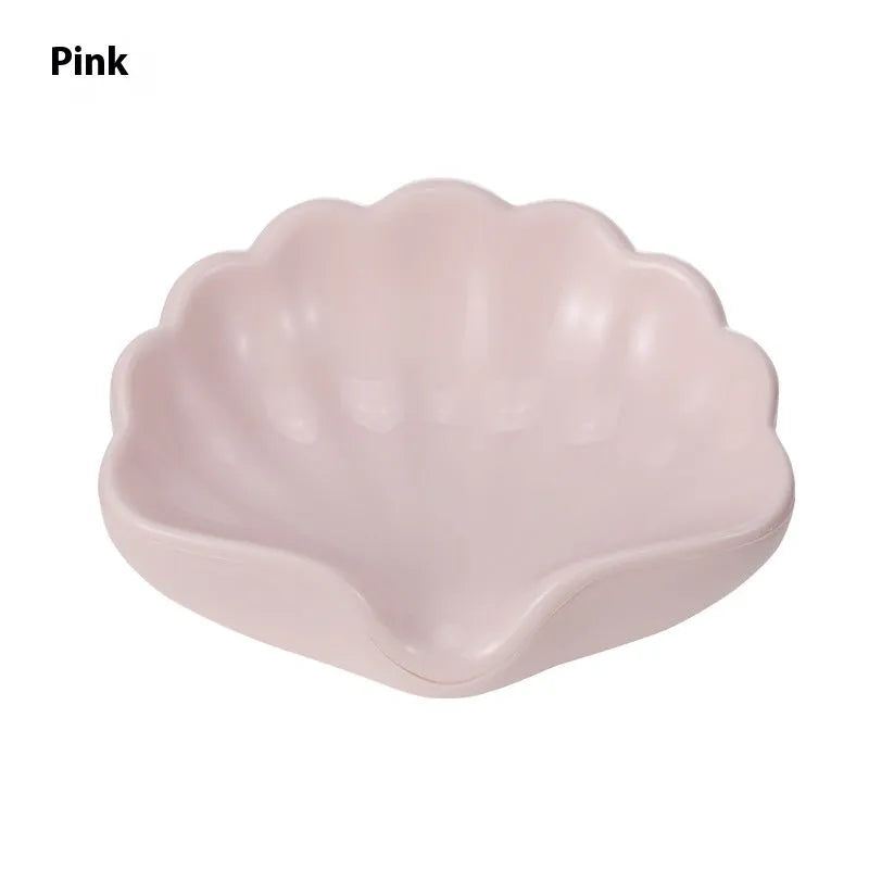 White and pink plastic shell-shaped soap dish for bathroom use