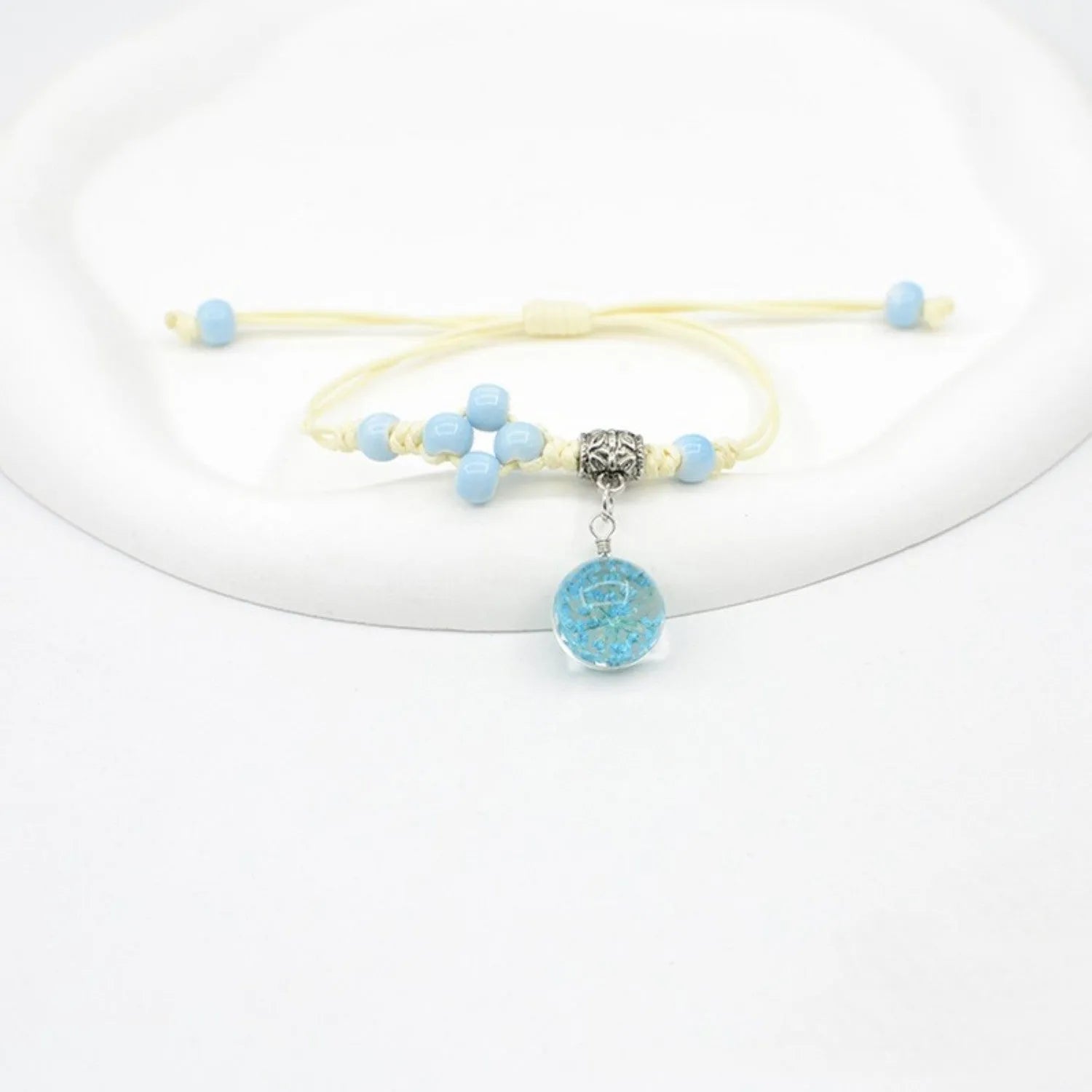 Glass dried flower bracelet with preserved flowers inside clear beads, available in multiple colours