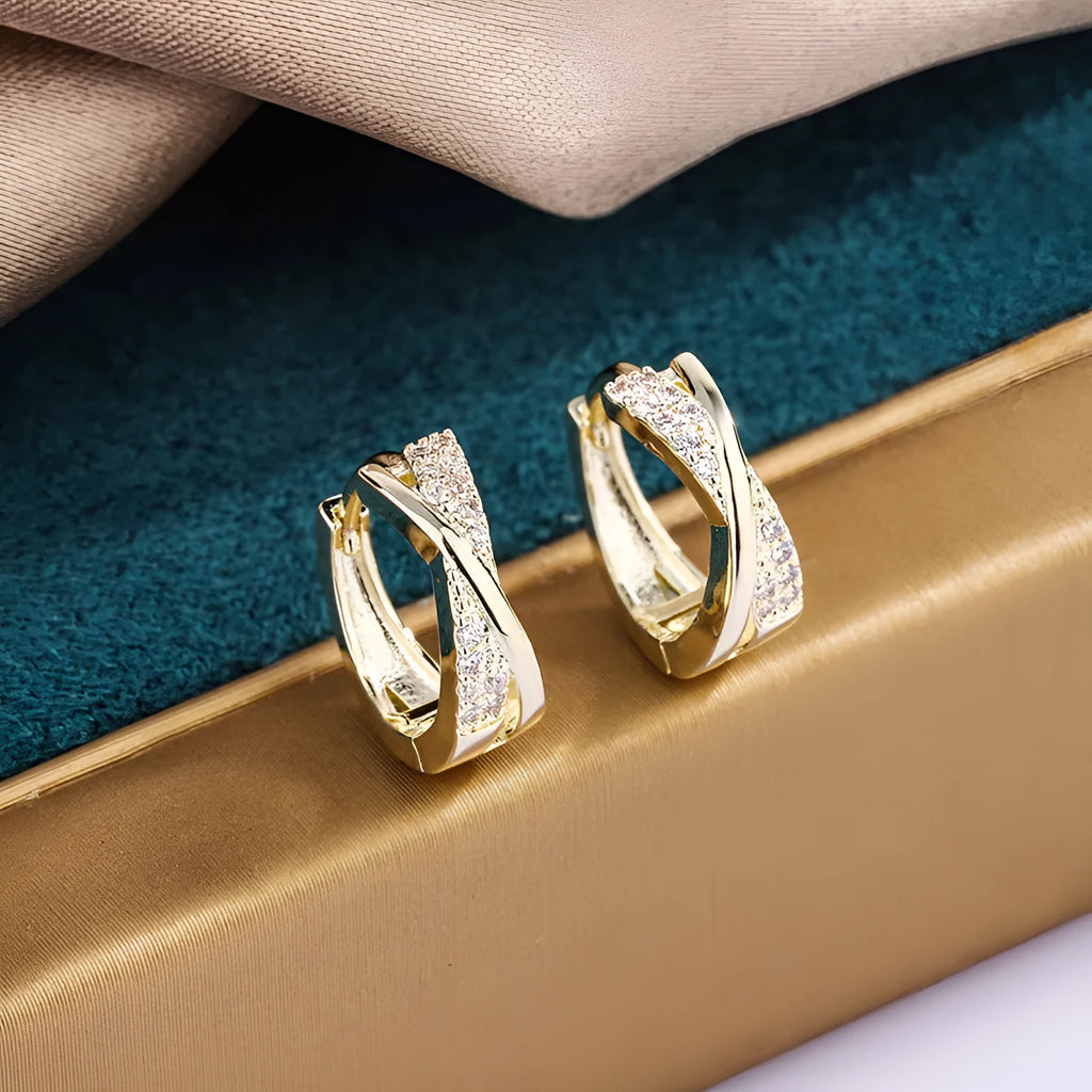 Geometric copper drop earrings with 14K yellow zircon treatment, showing structured shape and metallic finish