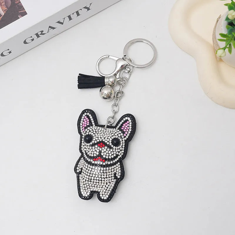 Close-up of a French dog-themed rhinestone keychain pendant with a cartoon bear design, in caramel colour.