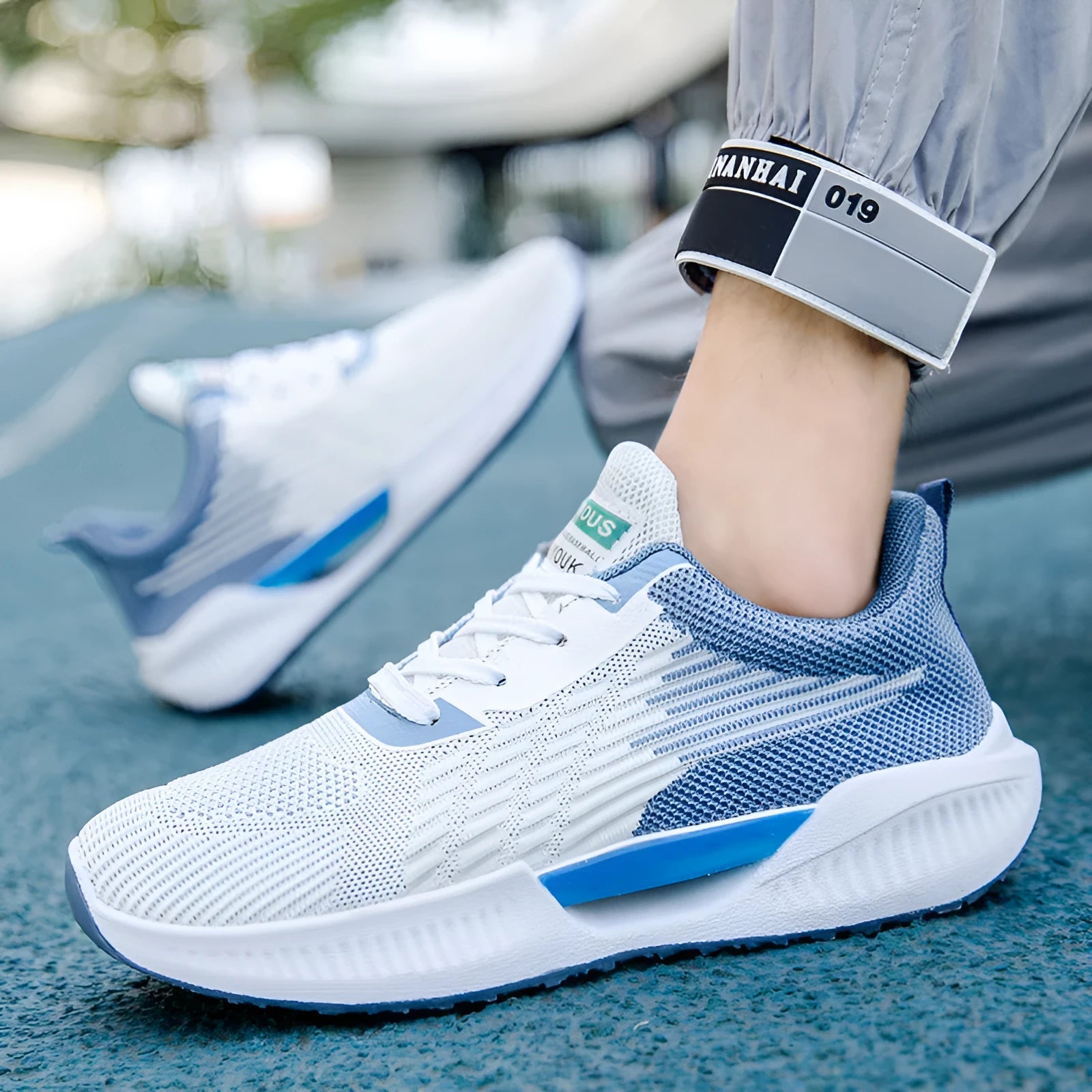 Men's blue breathable mesh casual shoes with round toe and plastic sole on a white background.