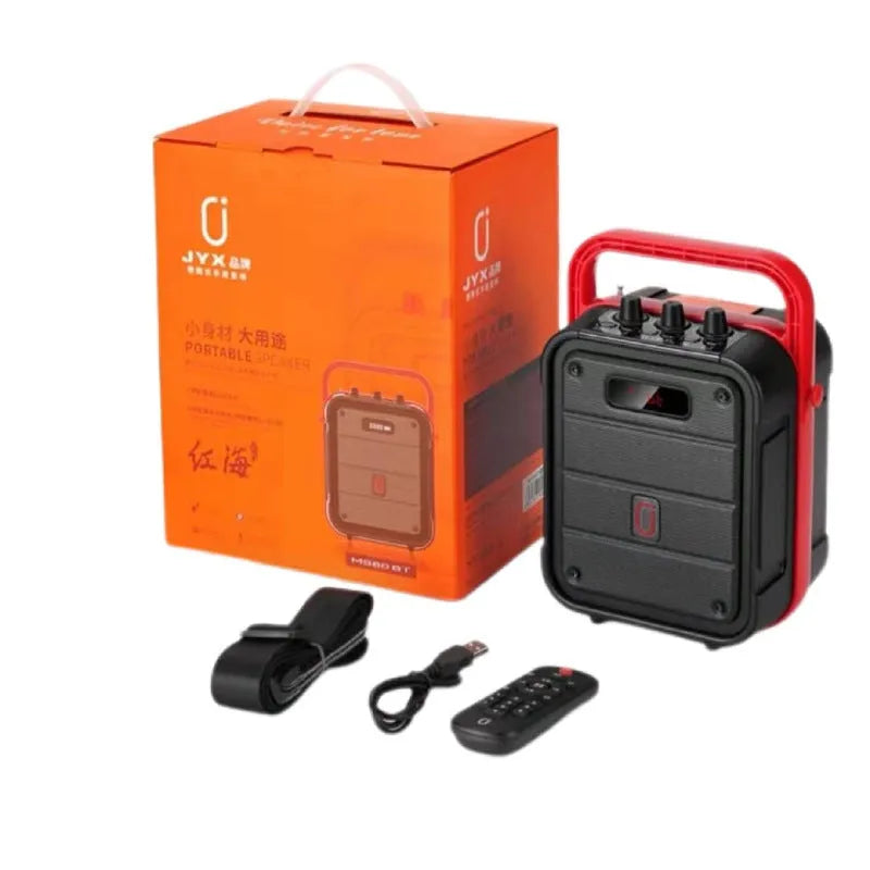 Portable black Bluetooth speaker with a wireless microphone, remote control, and carry strap.
