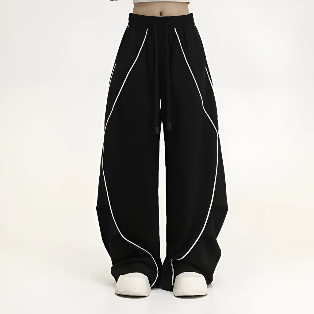 Black striped pleated hip hop trousers with wide-leg design shown flat