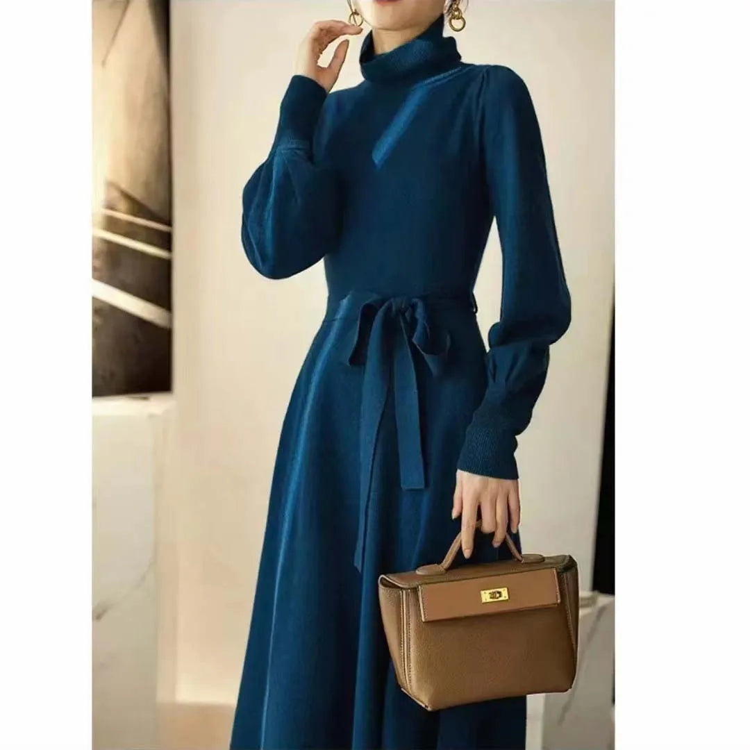 Rose red knitted turtleneck pullover dress with long sleeves and a loose, mid-length skirt with an elasticated waist.