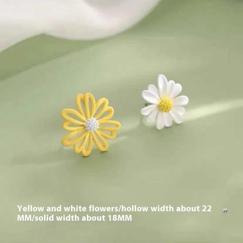 A pair of cartoon-style flower stud earrings made from alloy, shown in blue and orange colour contrast.