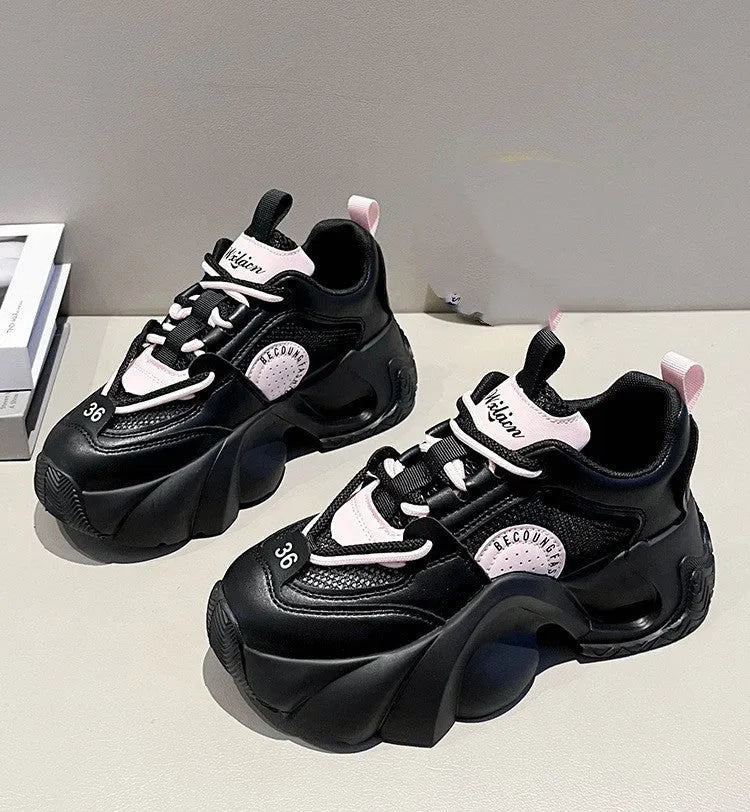 Women's pink sneakers with cross straps and thick sole showing side profile