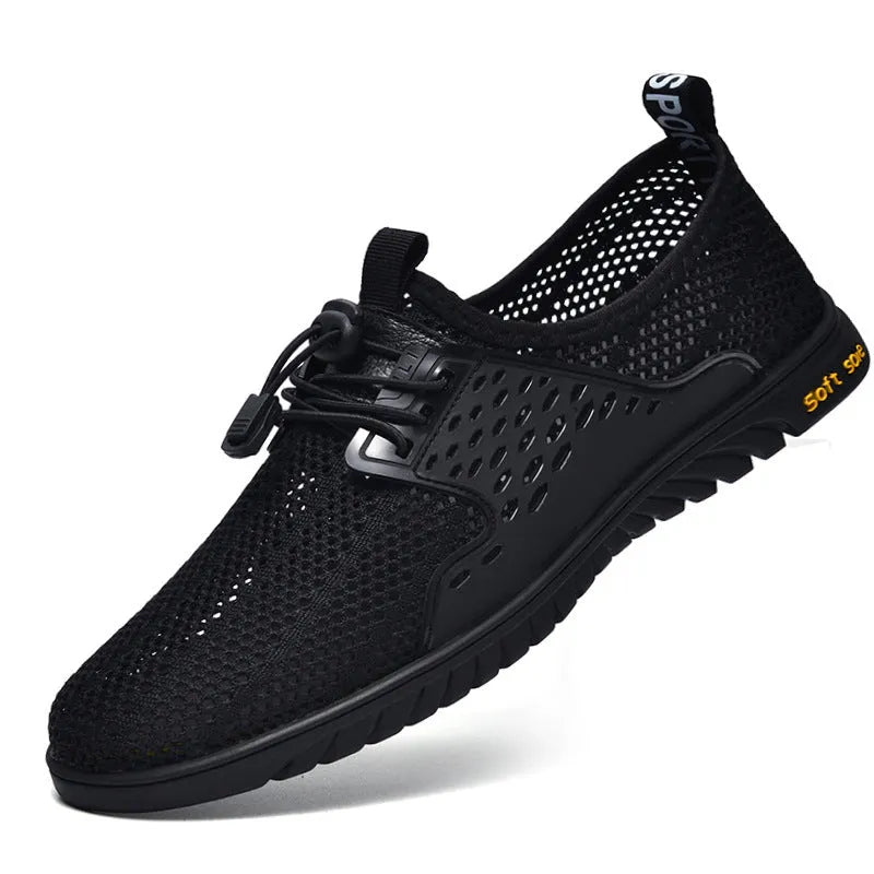 Men's black mesh casual sports shoe with elastic band fastening and rubber sole, shown on a white background.