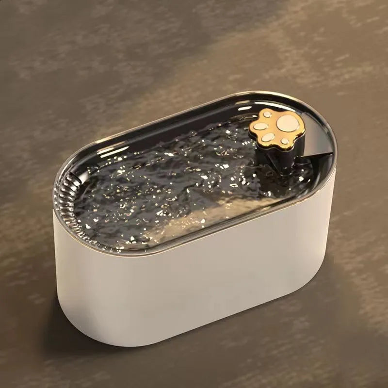Blue automatic pet water fountain with filter on a floor next to a cat