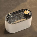 Blue automatic pet water fountain with filter on a floor next to a cat