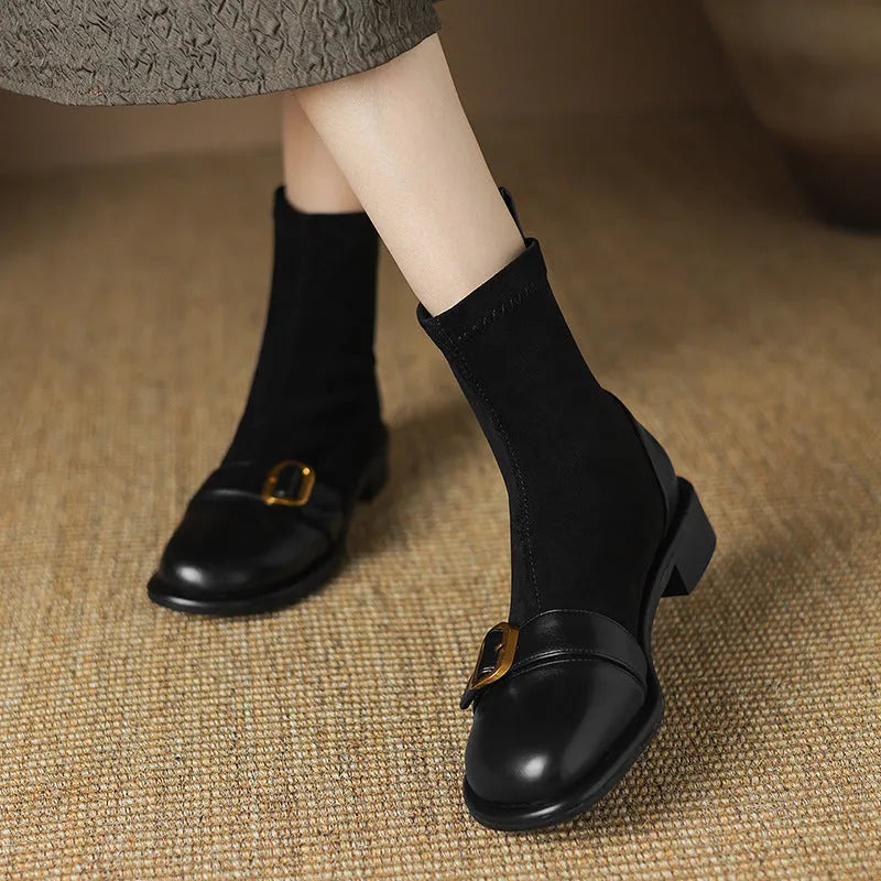 Women's black low heel Martin boots with buckle stitching and front lace-up fastening on a round toe.