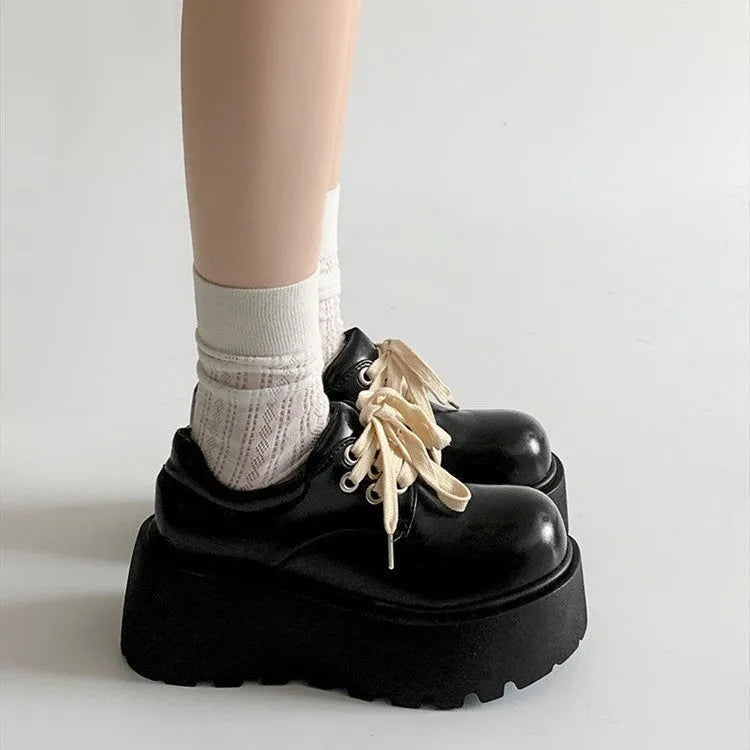 Matte black women's lace-up ankle boots with a chunky heel and thick sole.