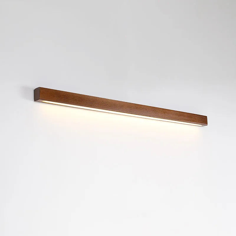 Walnut colour solid wood and acrylic LED strip wall lamp in three different lengths.