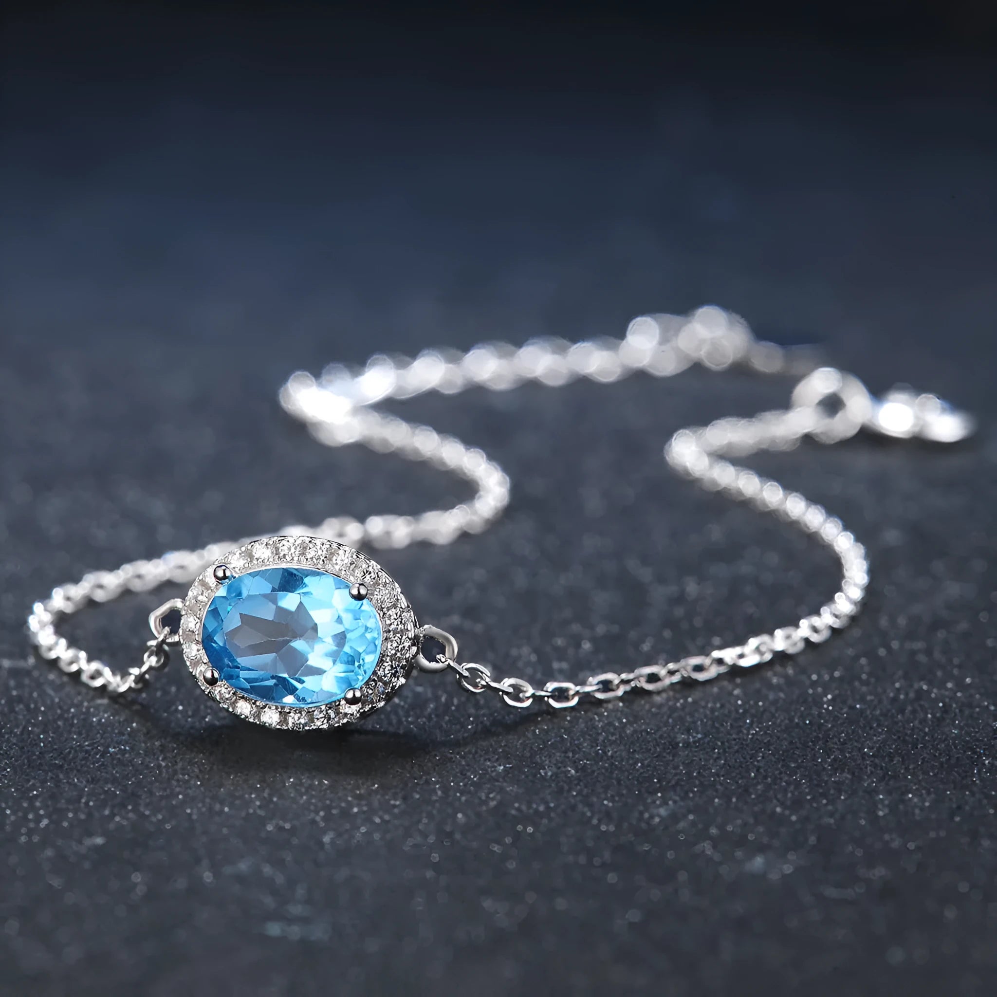 925 sterling silver geometric jewellery set with Blue Topaz gems showing necklace, earrings, ring, and pendant