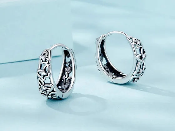Sterling silver S925 retro hollow butterfly earrings with zircon details on a white background.