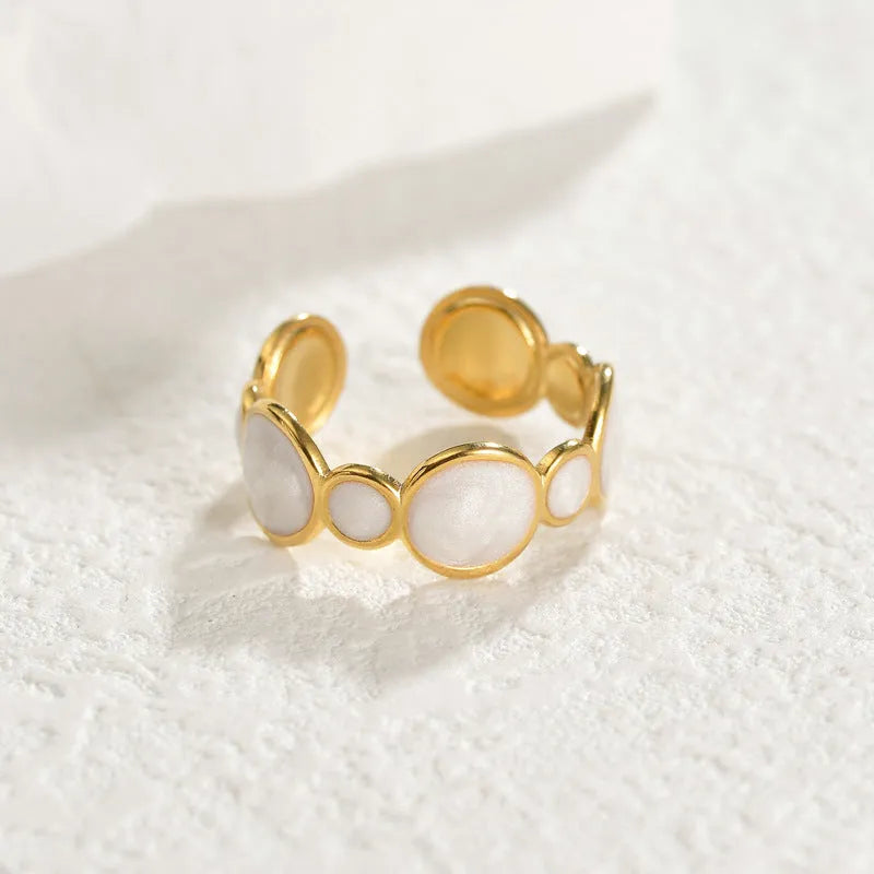 Silver-tone geometric stainless steel ring with an adjustable opening on a plain background.