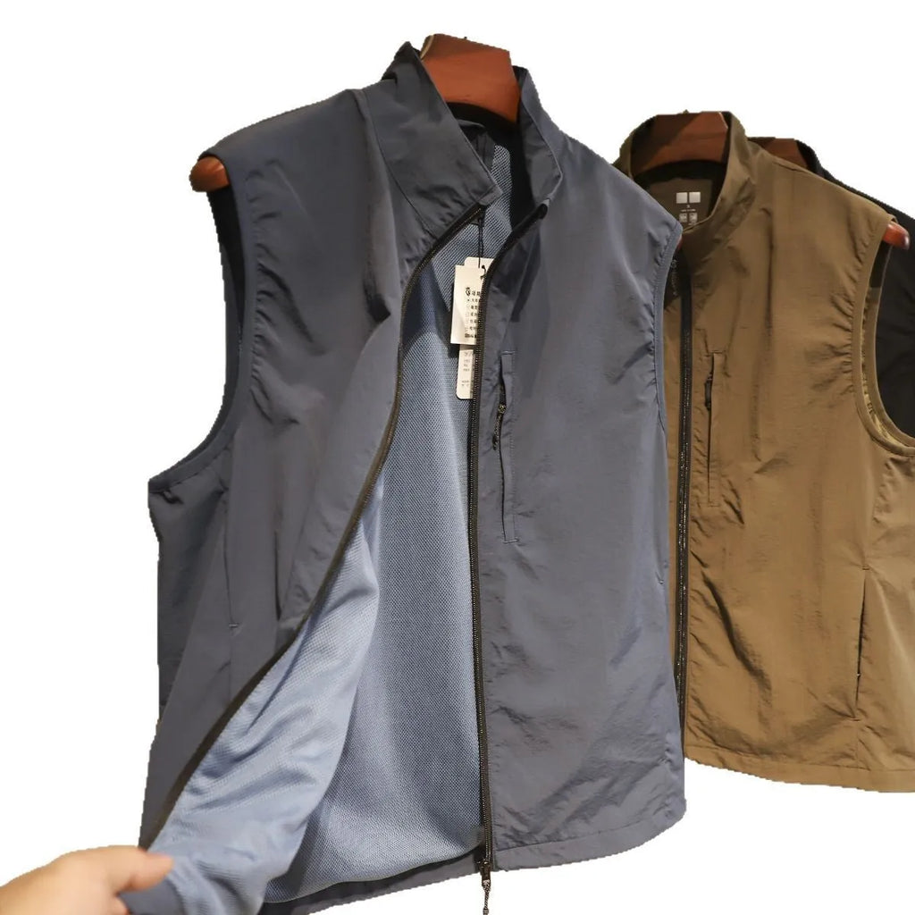 Men's straight cut nylon vest in army green with side seam pockets on a hanger.