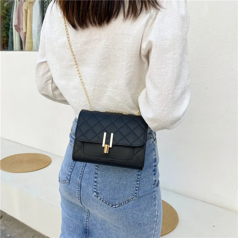 Women's minimalist crossbody bag with diamond lattice chain design in PU leather, showing adjustable strap and solid colour options
