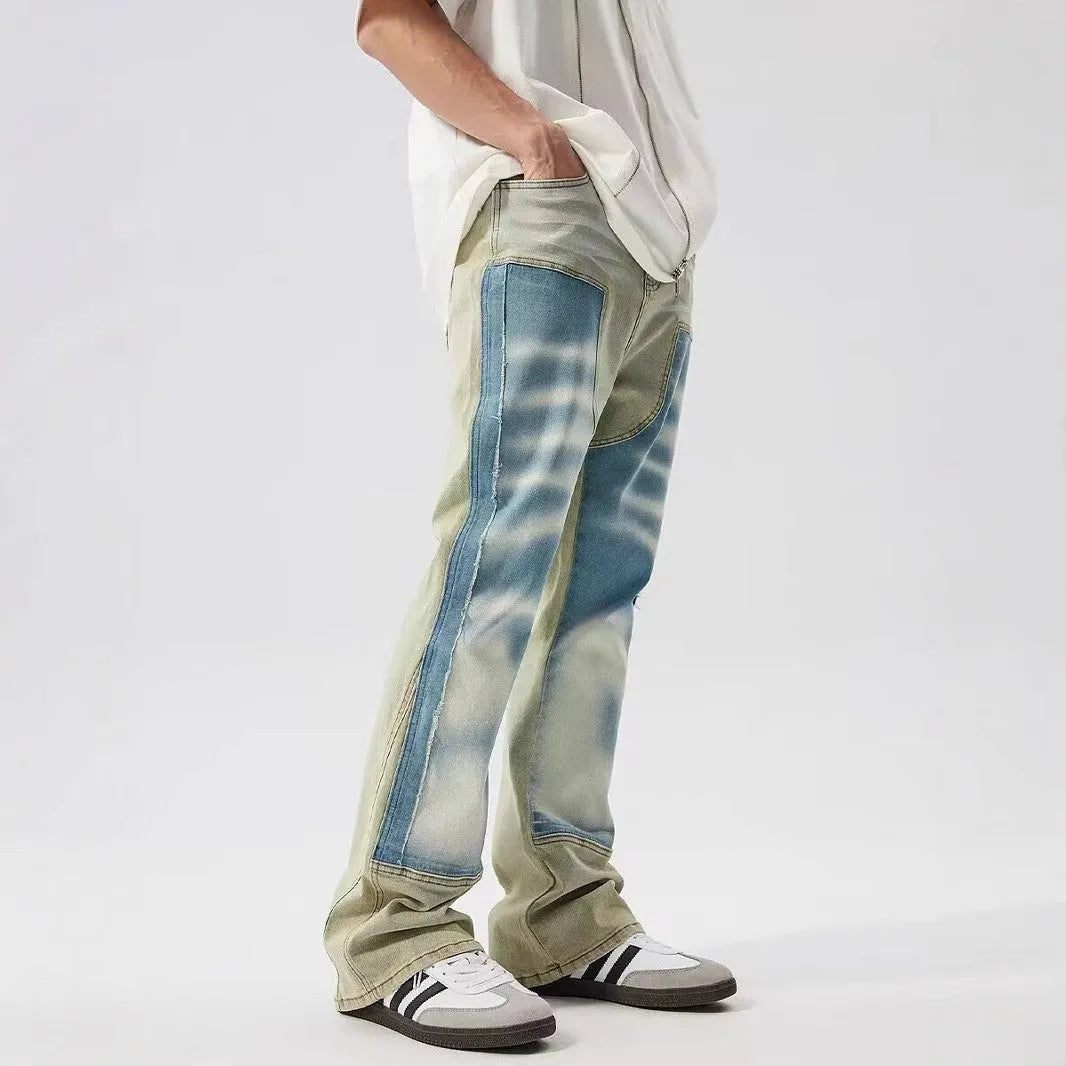 Men's yellow and blue patchwork jeans with a retro splash-ink damaged design on the legs.