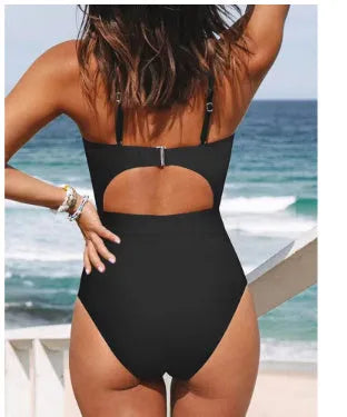 Solid colour women's one-piece swimsuit with a cross-back backless design, shown in black.