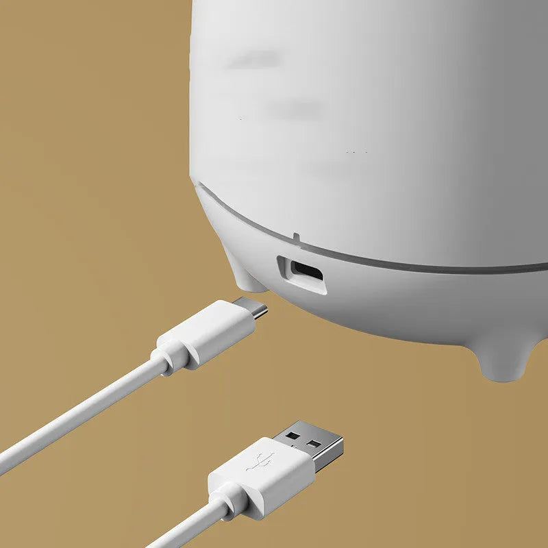 White volcano-shaped ultrasonic humidifier and aromatherapy diffuser with USB cable.