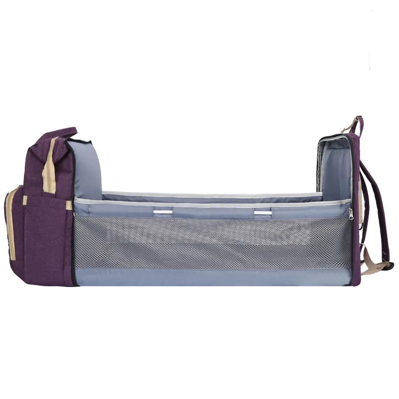 Lightweight nylon mother and baby bag with USB port, shown folded and in use with curved shoulder strap.