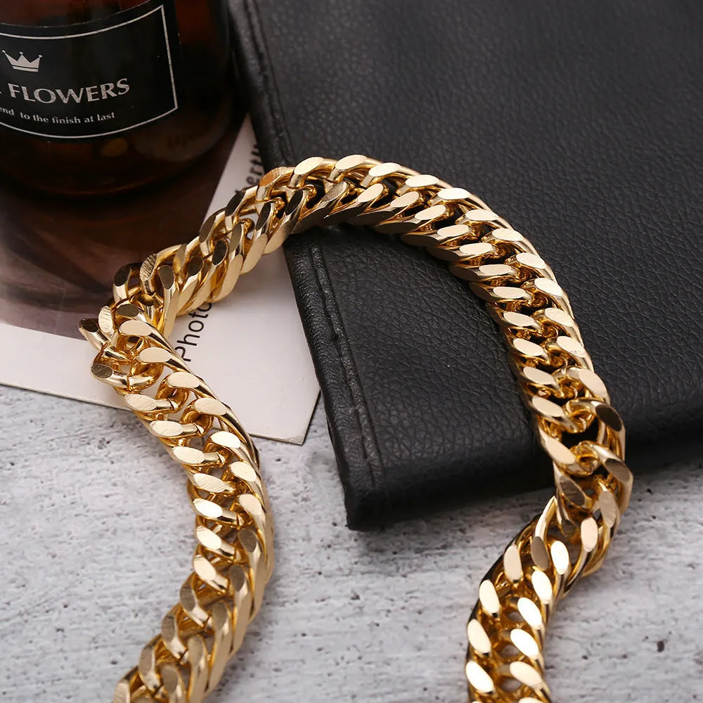 Gold women's thick chain necklace with 32cm length on a plain background.