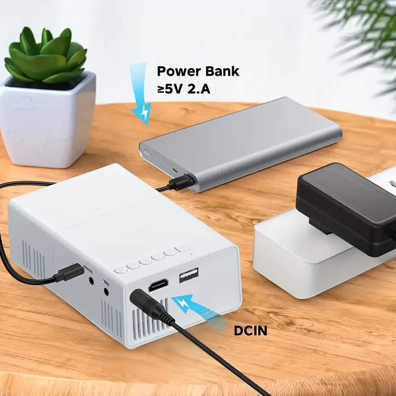 M100 mini LED projector showing 100-inch projection with remote control and cables