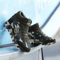 Women's green camouflage canvas sneakers with rubber sole on white background