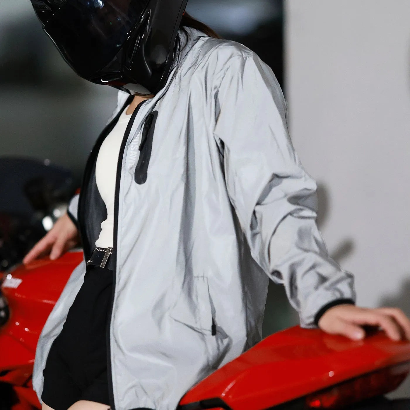Silver waterproof polyester long sleeved coat on a hanger, showing front design.