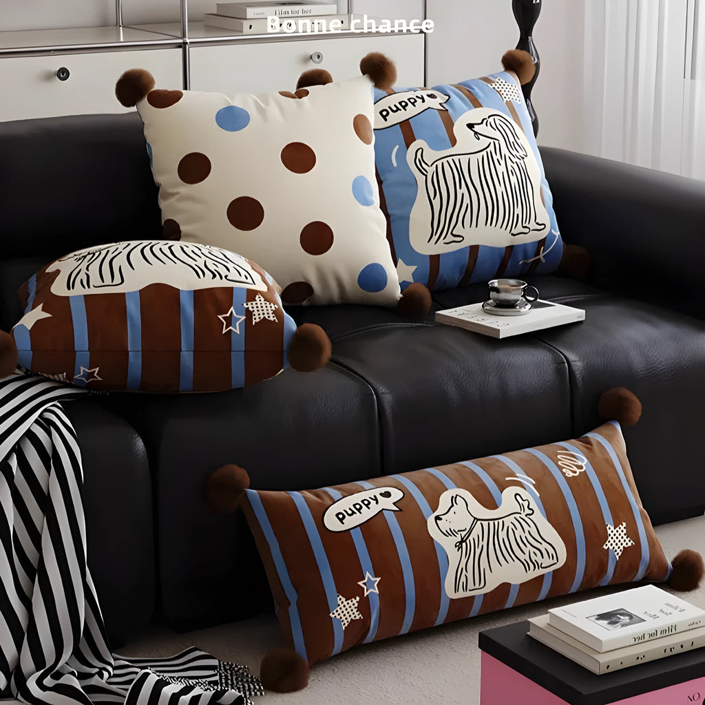 Blue cartoon animal print square sofa cushion on a grey sofa.