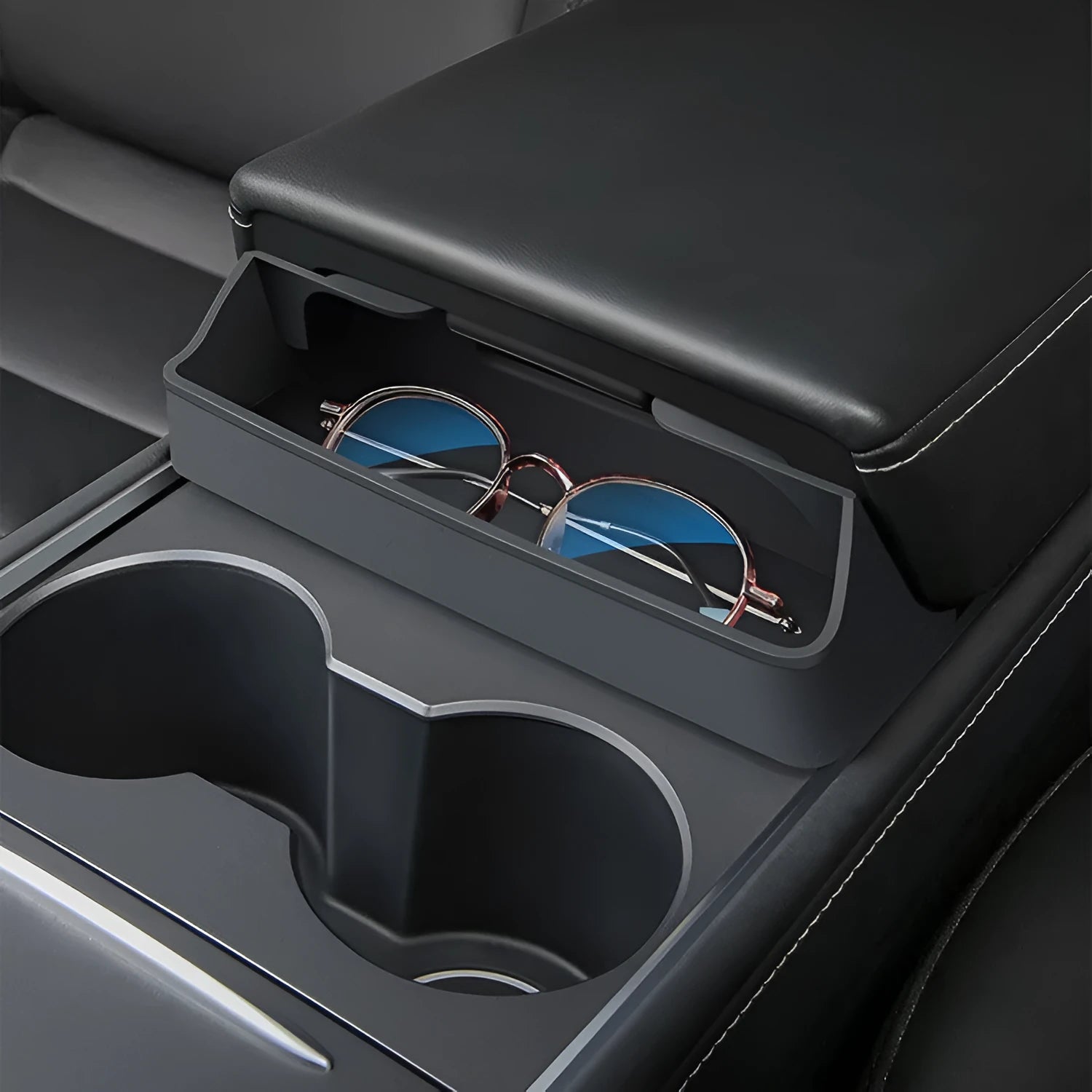 Black silicone glasses case installed in Tesla Model 3/Y centre console armrest compartment