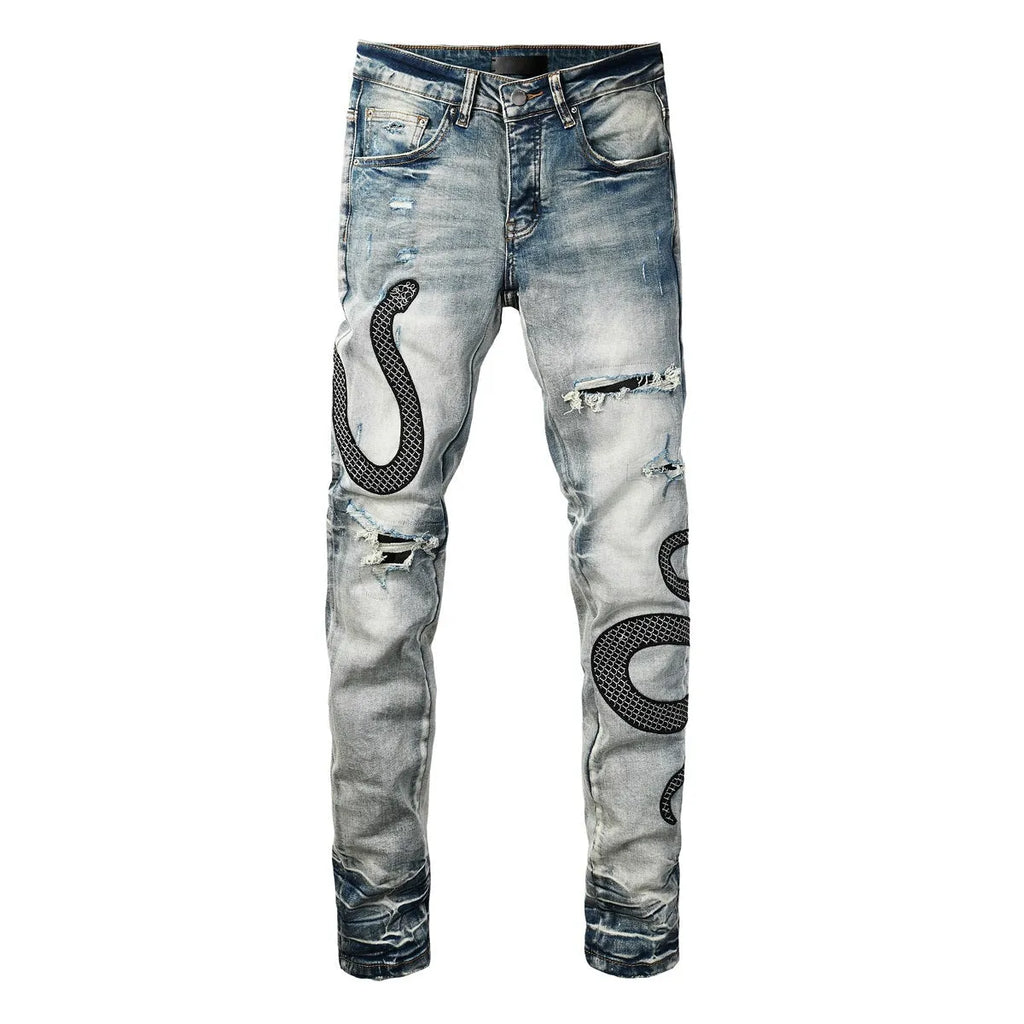 Close-up of vintage blue wash distressed skinny jeans with a tapered leg and button fly.