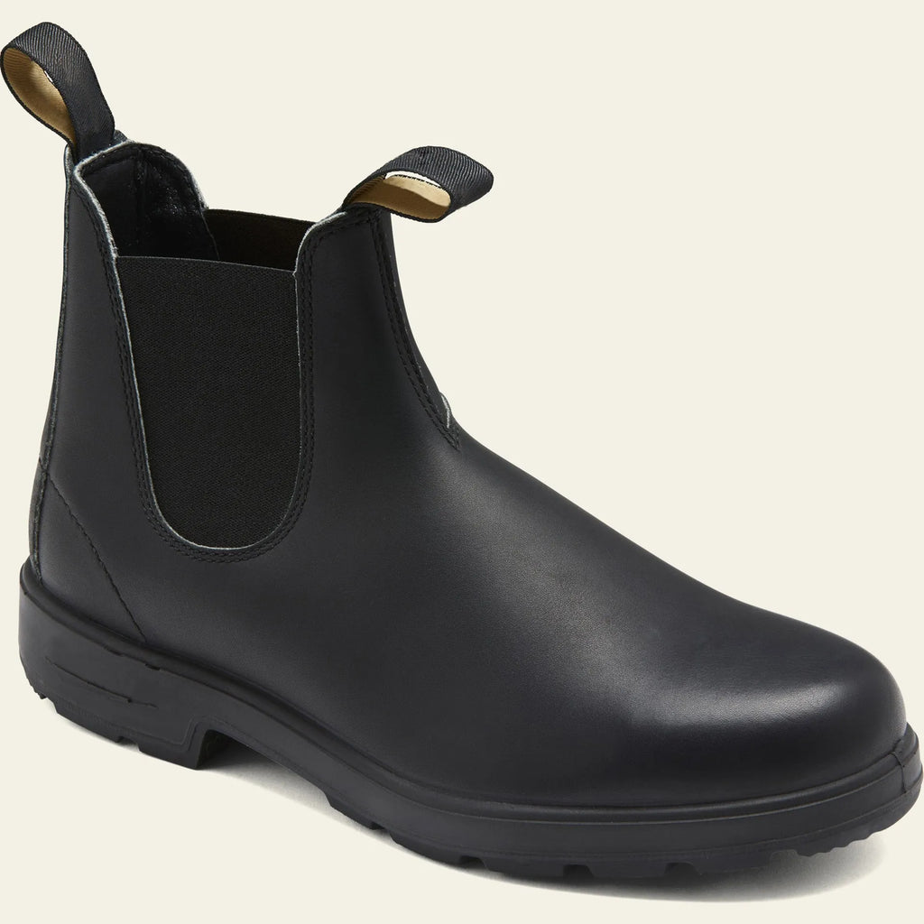 Vintage frosted faux leather Chelsea boots for men and women on a neutral background.