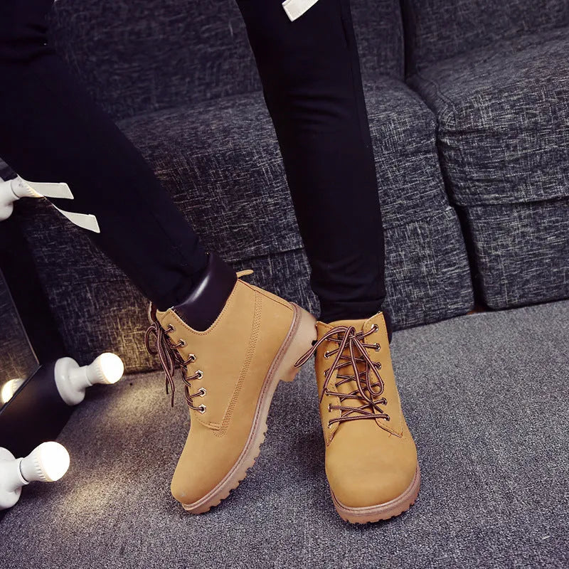 Men's pink Martin boots with velvet lining, flat sole, and round toe on a lace-up high-top.