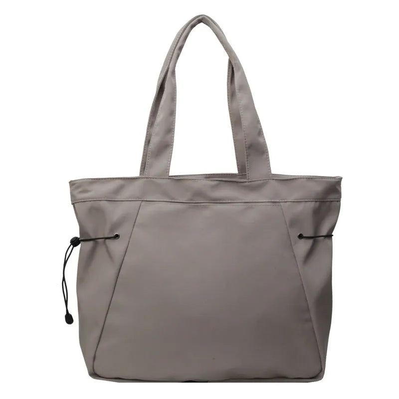 Soft Oxford cloth folding tote bag in a choice of five colours: black, brown, dark grey, light grey, and purple.