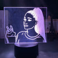 Slim white acrylic 3D decorative night light with LED illumination and remote control on a table.