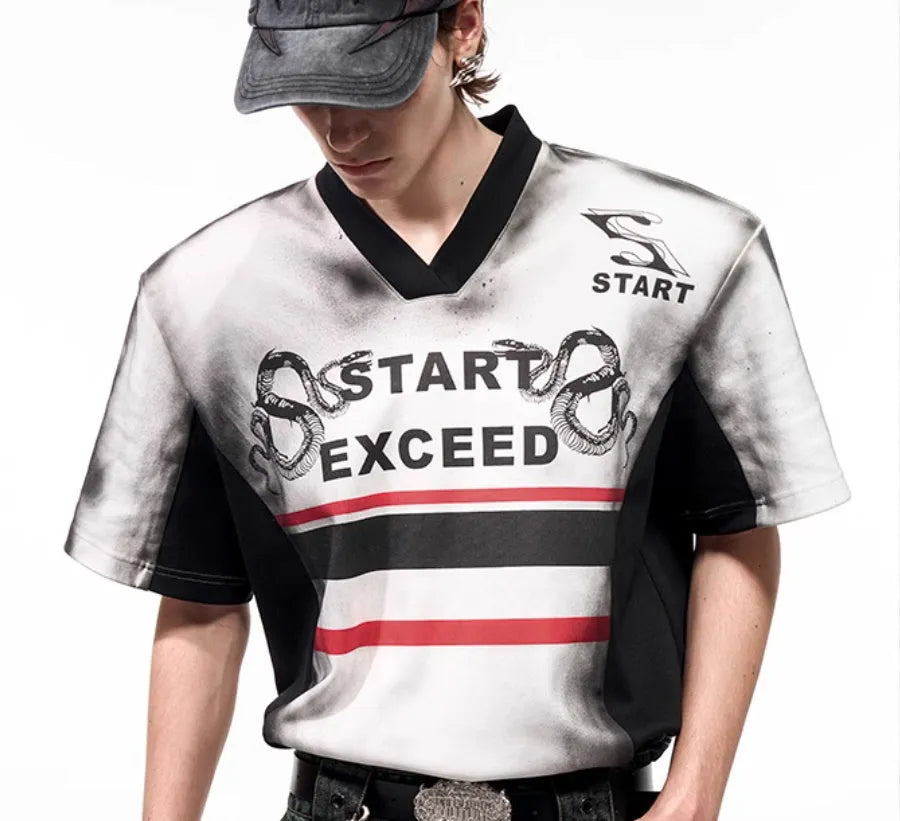 V-neck short sleeve top with padded shoulders featuring letter snake pattern print