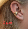 Gold starfish and conch shell earrings with electroplated finish and detailed coastal designs