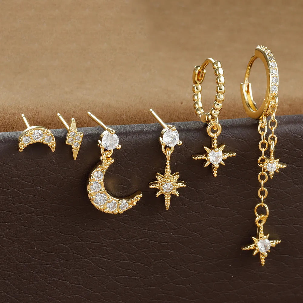 Gold-coloured chain tassel earrings with six dangling elements and zircon stud details on copper construction.