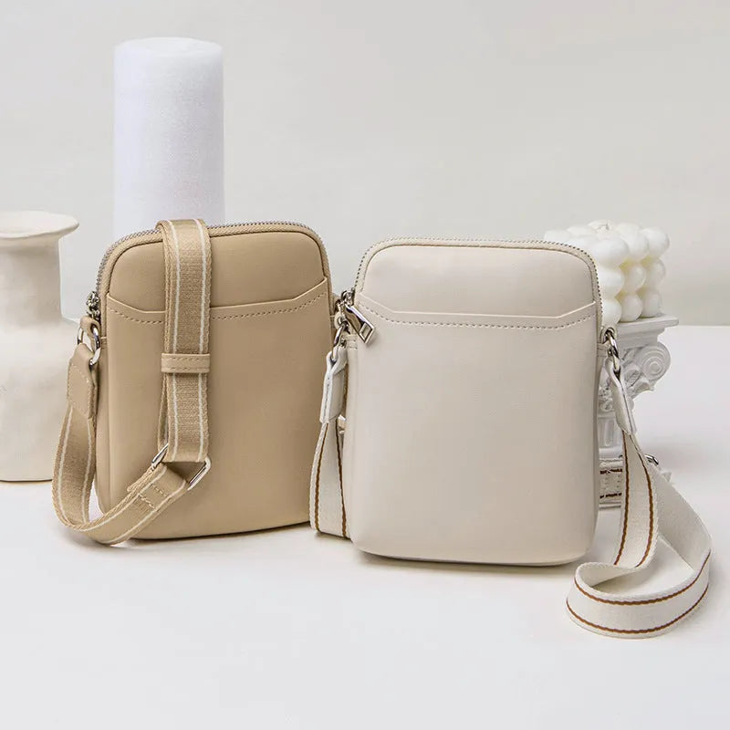 Small solid colour crossbody shoulder bag for women, shown in beige.