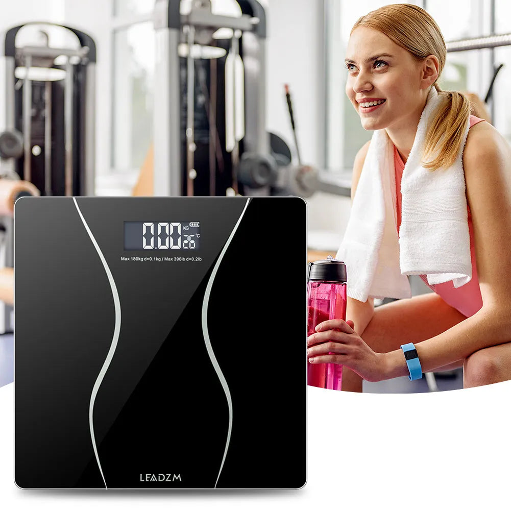 Black electronic digital bathroom scale on a bathroom floor