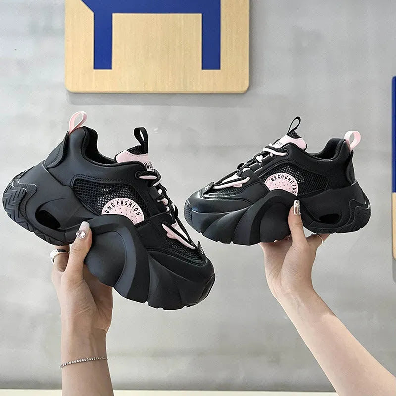 Women's pink sneakers with cross straps and thick sole showing side profile