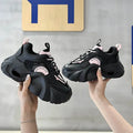 Women's pink sneakers with cross straps and thick sole showing side profile